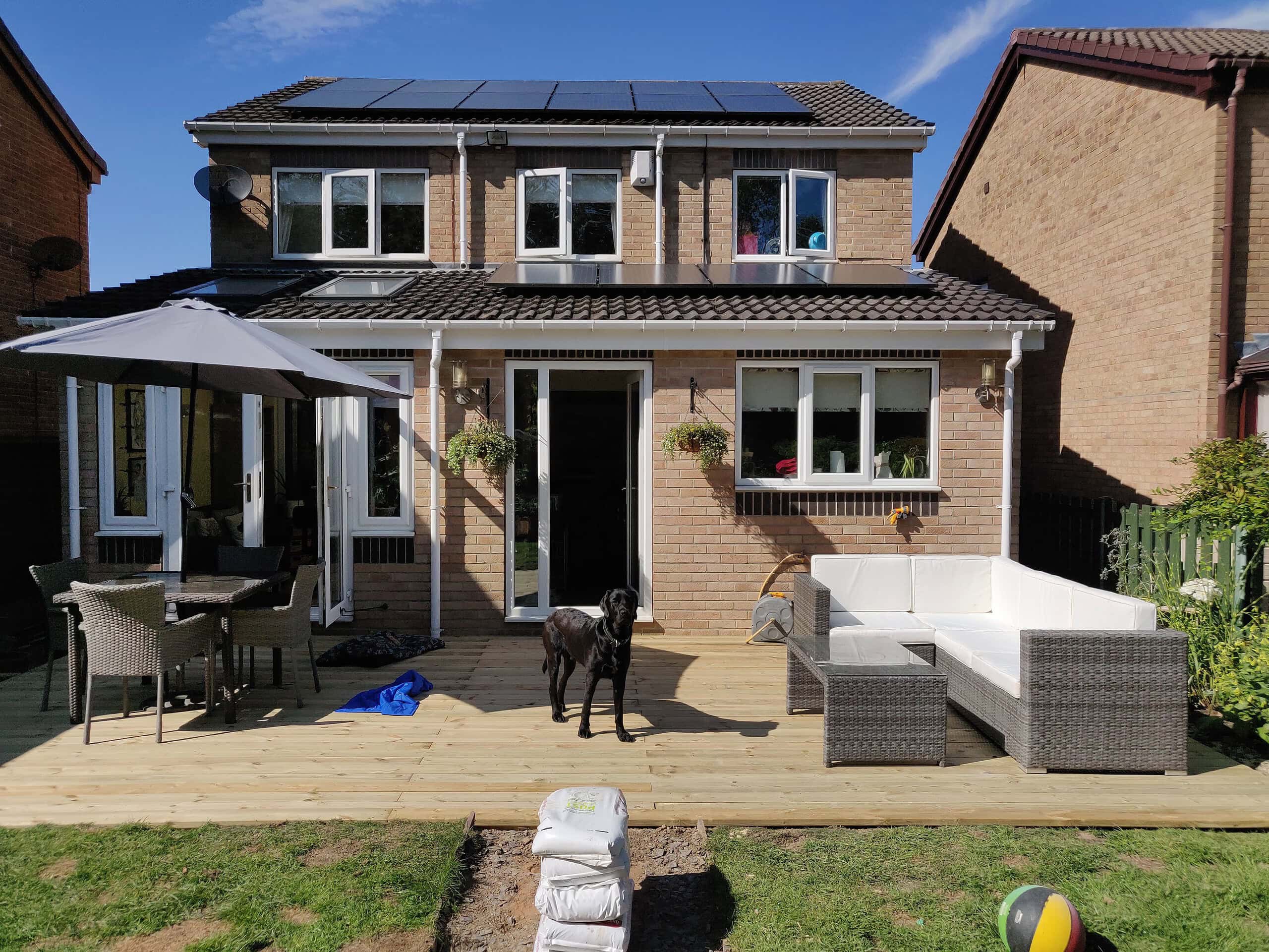 wooden decking used as a patio in a back garden with patio furniture