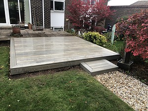 raised wooden decking with peddle path to turfed garden