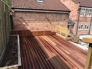 raised wooden decking installed in a back garden