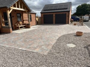 New block paving driveway installation bordered by gravel in a Nottinghamshire residential property.