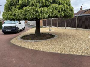 Professional garden landscaping with gravel driveway and perimeter fence in Nottinghamshire.